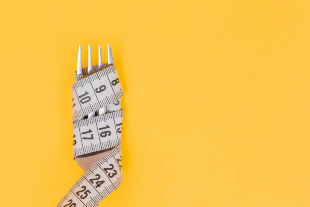 fork wrapped with measuring tape